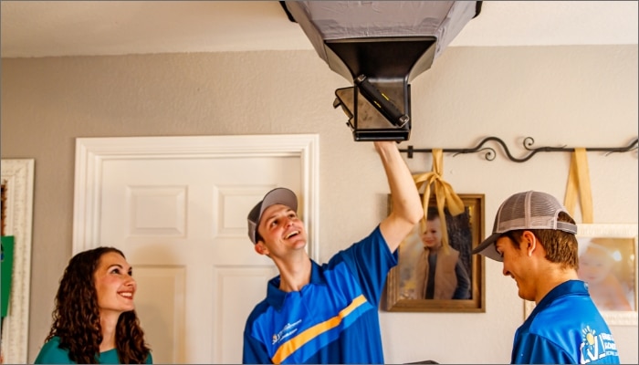 technicians inspecting air duct in a customer's home